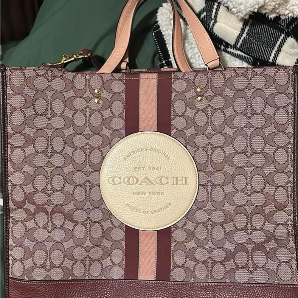 Large tote with camera strap to wear as crossbody.